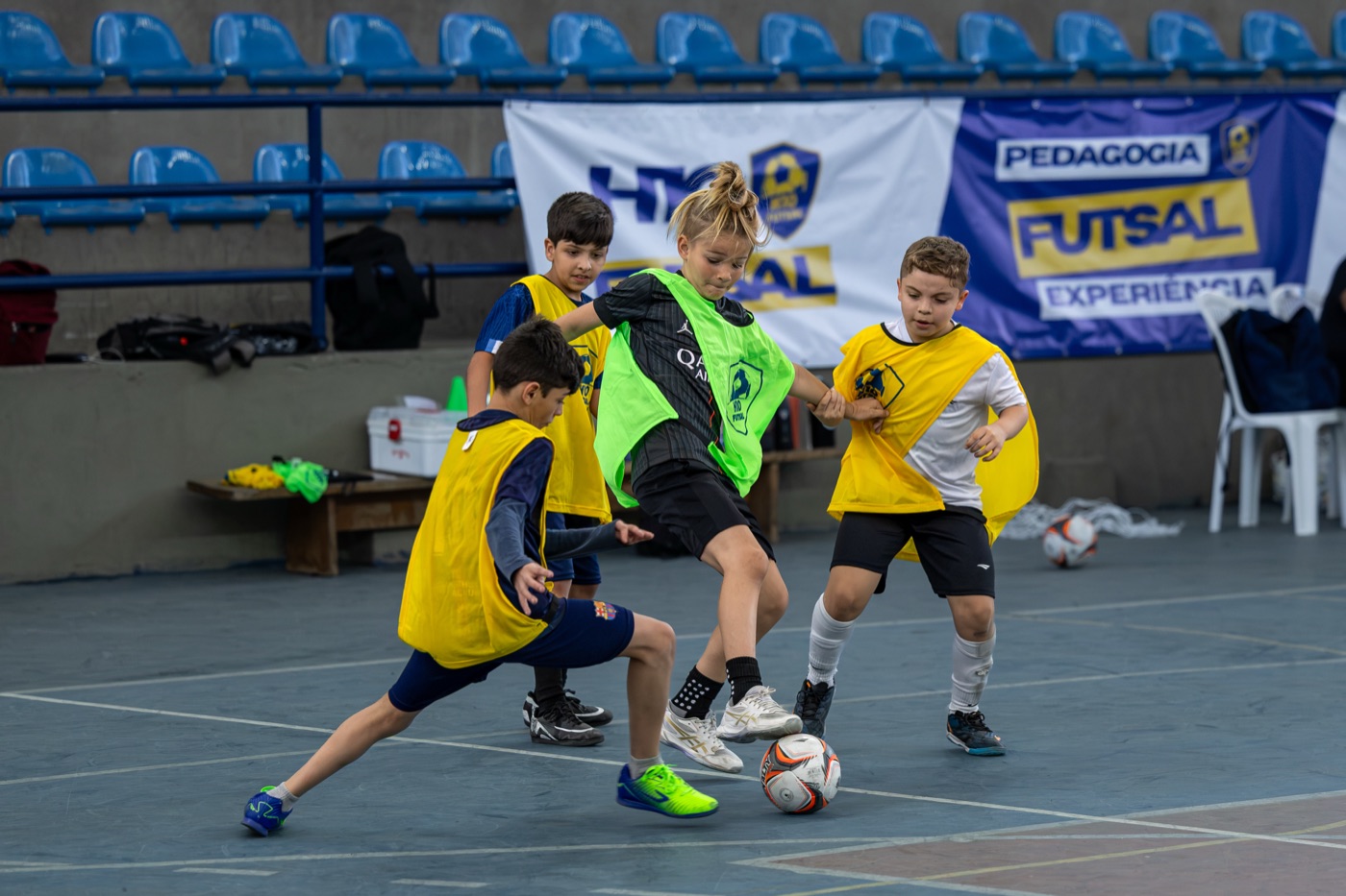 Alunos disputando a bola em jogo durante a aula